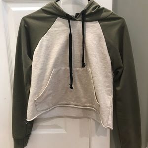 A cream and olive green crop top hoodie